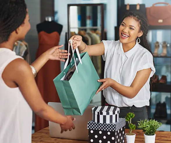 Shopper receiving purchases from a retail assistant