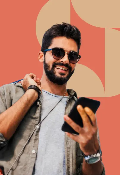 Man checking his phone while carrying shopping bags