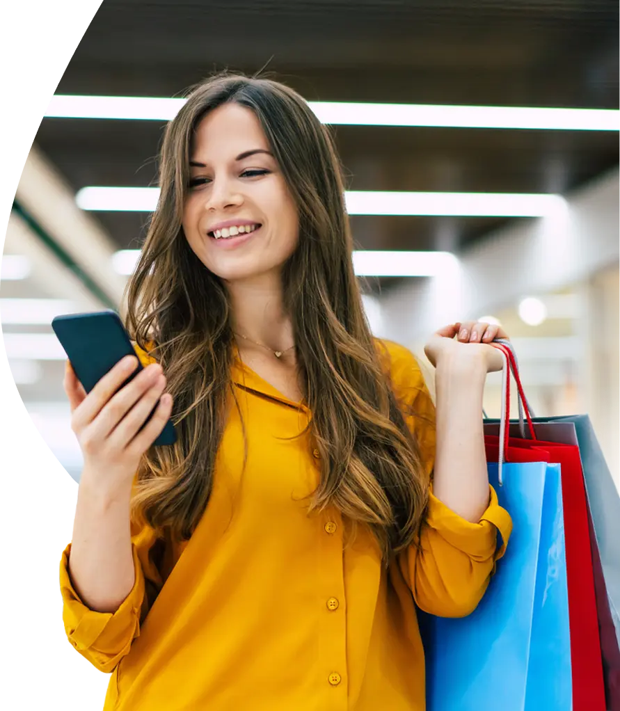 Woman checking rewards on her phone while shopping